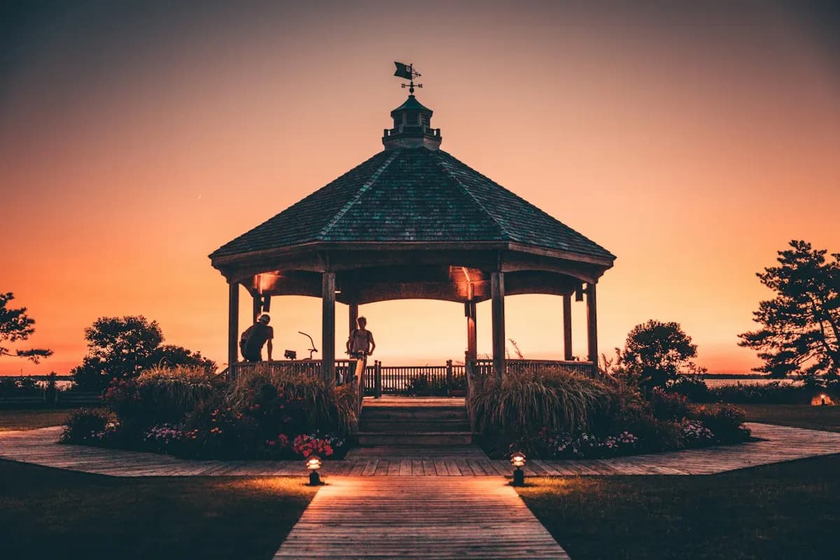 Garden gazebo at sunset with lighting along the path