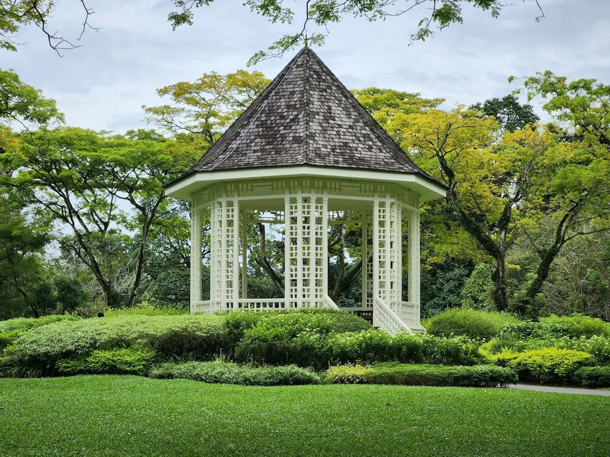 White gazebo with a pitched shingle roof